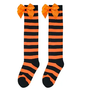 Detailed view of Halloween striped over-the-knee socks with orange satin bows