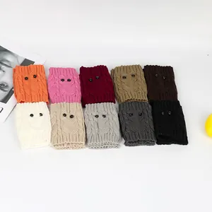 Detailed view of colorful knitted owl-themed leg warmers with cute bead eyes decoration