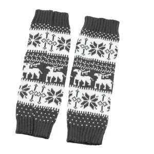 Macro view of the reindeer and snowflake knitted patterns on grey wool leg warmers.