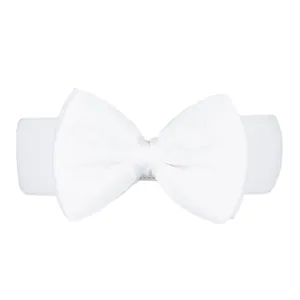 Close-up detail of a large white chiffon bow on an elastic stretch waist belt for dresses.