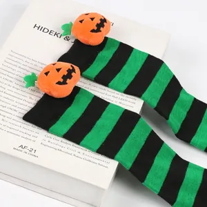 Halloween green and black striped over-the-knee socks for kids with pumpkin plush dolls