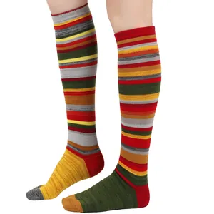 Close-up detail showing the vibrant colorful retro striped pattern of knee-high cotton socks