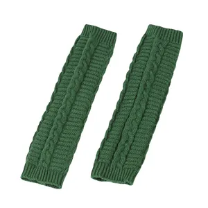 Detailed macro view of dark green cable-knit acrylic arm warmers with ribbed cuffs