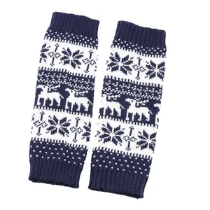 Detailed knit texture of navy blue leg warmers with Christmas snowflake and deer patterns