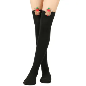 Close-up of the plush reindeer decoration on black over-the-knee Christmas socks.