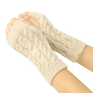 Macro view of the intricate cable knit pattern on warm beige fingerless gloves