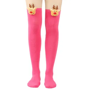 Detail view of pink over-the-knee Christmas socks with plush reindeer decor
