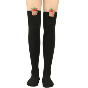 Close-up of black over-the-knee Christmas socks featuring 3D reindeer plush decor