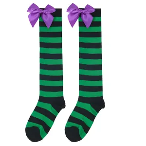 Detail view of children's Halloween over-the-knee socks with green stripes and purple bows