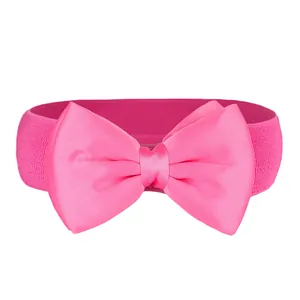 Detail showing the textured pink elastic band and large chiffon bow on the waist belt