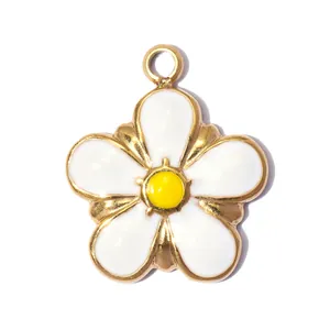 Close-up of a white and yellow enamel daisy flower pendant made of golden stainless steel
