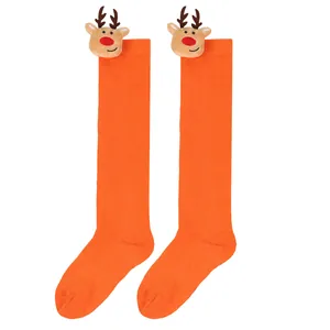 Bright orange children's Christmas knee-high socks featuring cute plush reindeer dolls