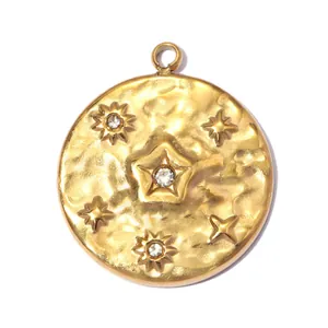 Detailed macro view of a vintage gold star and sun embossed stainless steel pendant