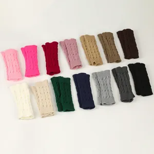 Cable knit fingerless gloves displayed in a variety of warm winter colors on white