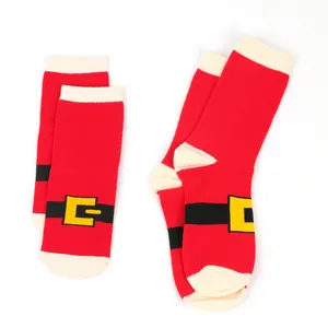 A detail shot of fuzzy red Christmas socks with a decorative Santa Claus belt buckle motif.