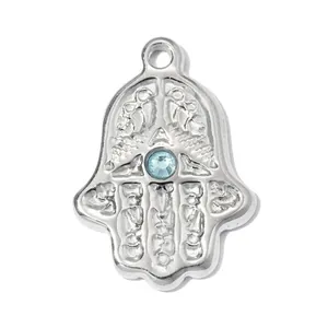 Detailed view of silver stainless steel Hamsa hand pendant with a blue rhinestone center.