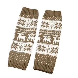 Detailed view of brown knit leg warmers with white snowflake and reindeer patterns
