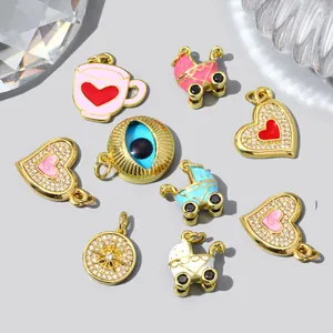 Detailed view of colorful DIY jewelry charms including evil eye, hearts and strollers