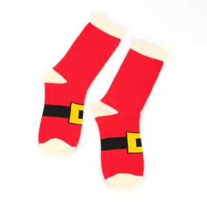 Close-up of festive red Christmas socks with Santa Claus belt buckle design