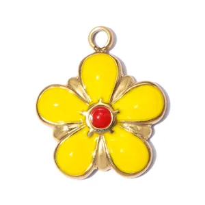 Detail view of a yellow enamel daisy flower pendant in stainless steel for DIY jewelry making.