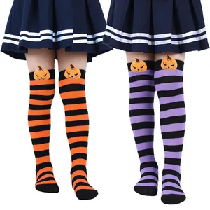 Detail of children's striped Halloween socks with plush pumpkin demon decoration