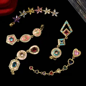Detailed view of various 18k gold plated copper zircon pendants with flower and eye motifs
