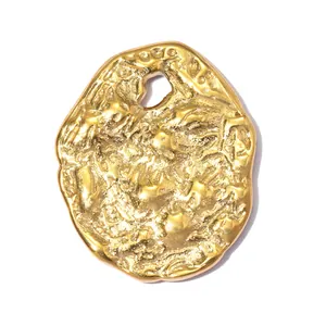 Close-up of a gold embossed stainless steel irregular coin pendant for DIY jewelry