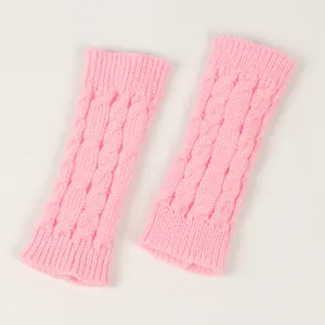 Detailed macro view of soft pink cable knit fingerless gloves and arm warmers texture