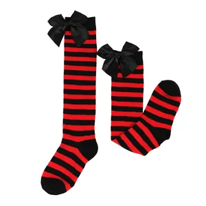 Red and black striped girls over-the-knee socks with large black bows for Halloween