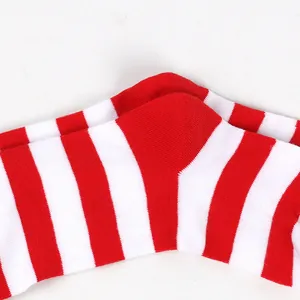 Detailed view of the soft knit texture on red and white striped Christmas socks for kids.
