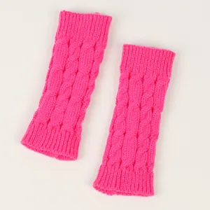 Close-up detail of neon pink cable knit arm warmers with thick textured pattern.