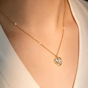 Close-up of 14k gold-plated heart necklace with sparkling 2ct moissanite stone.
