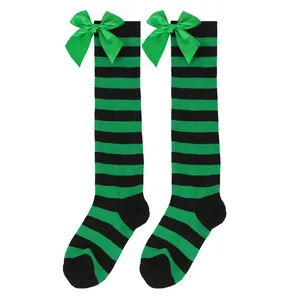 Festive girls green and black striped over-the-knee socks with large satin bow accent