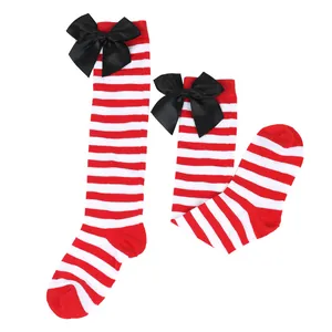 Detailed view of girls' red and white striped knee-high socks with black satin bows