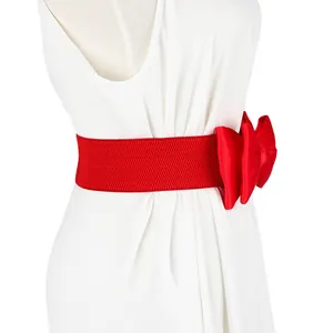 Detailed view of a wide red elastic waist belt with a large decorative chiffon bow
