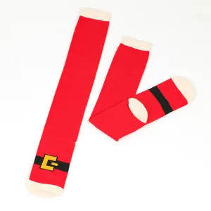 Detail view of festive red Christmas knee-high socks featuring a Santa belt pattern design