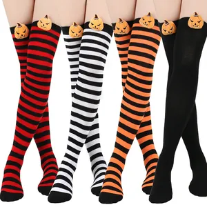 Close-up view of Halloween thigh-high socks featuring 3D pumpkin dolls and striped designs