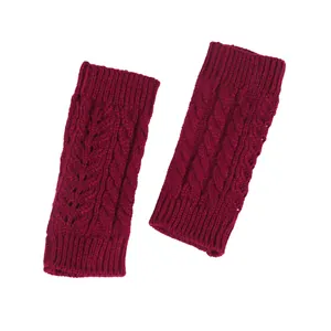 Close-up detail of burgundy cable knit fingerless gloves with hollow-out patterns