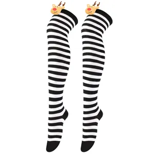 Detailed view of Christmas over-the-knee socks with black white stripes and reindeer decoration