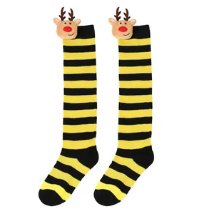 Detail view of yellow and black striped knee-high Christmas socks with reindeer doll