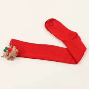 Close-up view of red Christmas over-the-knee stockings with 3D plush reindeer decoration