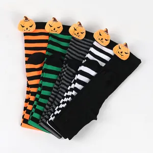 Halloween themed over-the-knee socks with striped patterns and pumpkin doll accents