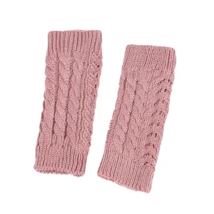 Detailed view of pink cable-knit fingerless gloves with intricate hollow patterns