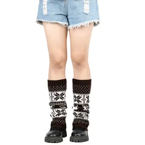 Detail view of thick knitted leg warmers with Christmas snowflake and deer patterns