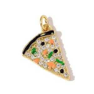 Macro detail view of a gold-plated pizza slice charm with sparkling cubic zirconia and enamel
