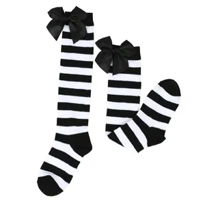 Black and white striped children's knee-high socks with large satin bows