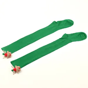 Detailed view of green over-the-knee Christmas socks featuring cute plush reindeer heads.