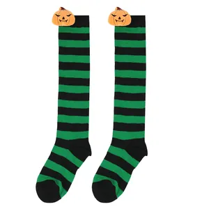 Halloween green and black striped knee-high socks featuring plush pumpkin head decorations.