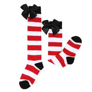 Detail view of red and white striped Halloween over-the-knee socks with black bows.