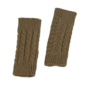 Macro view showing the intricate cable knit and hollow details of brown fingerless gloves